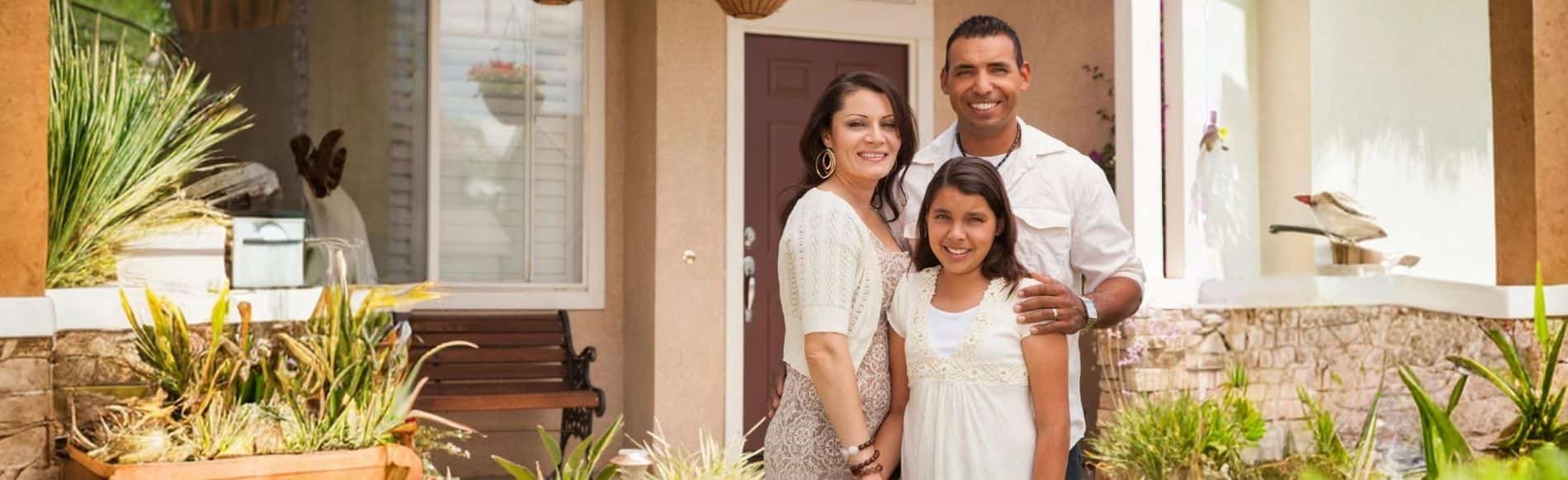 Family outside their home, where radon risks can still affect the home environment