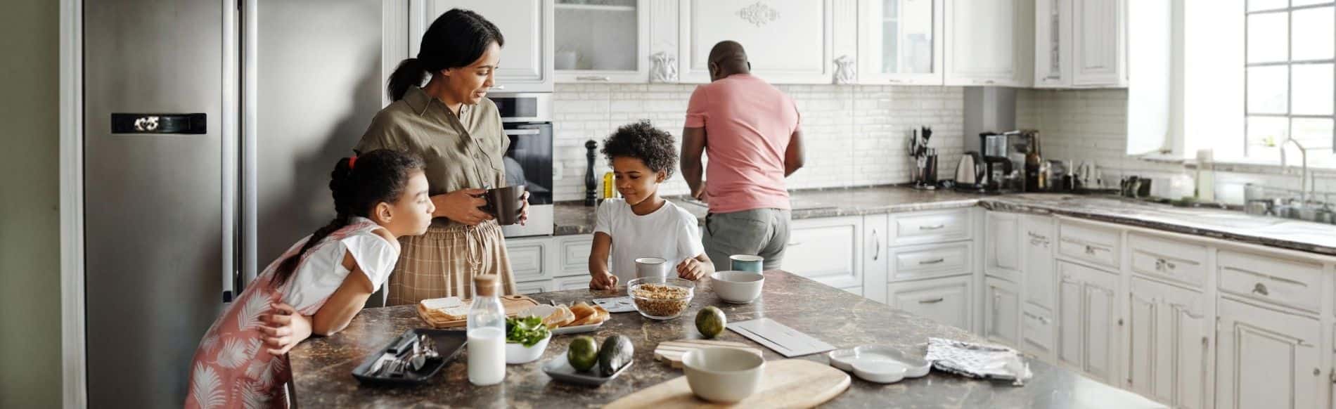 Family preparing breakfast together in a bright kitchen, symbolizing a safe and healthy home environment